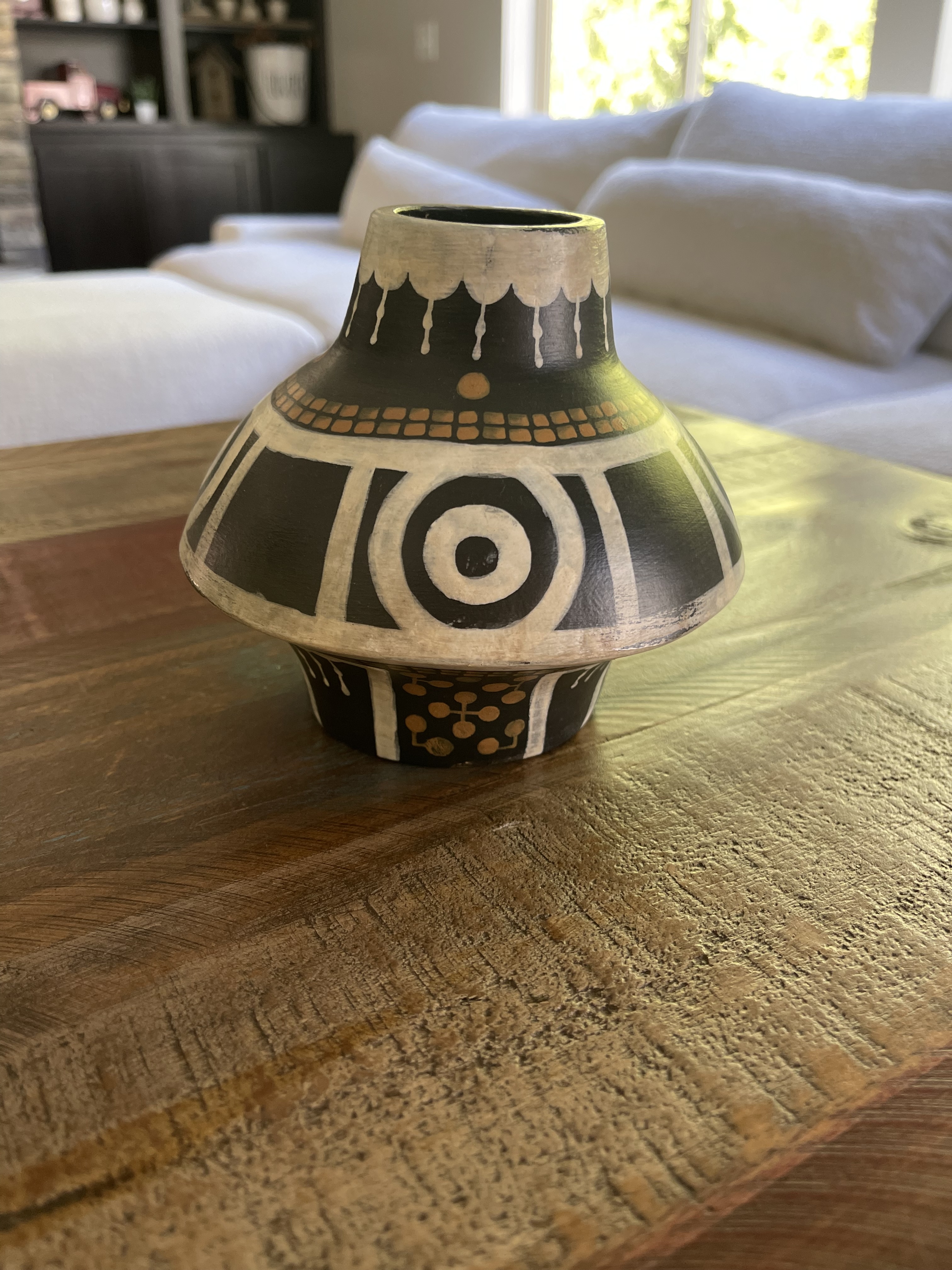 Alternate view of a geometric black ceramic jug on a wooden table